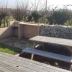 Outdoor bbq area with picnic benches