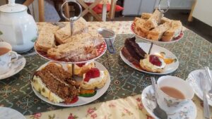 Afternnon tea with sandwhiches, cake and scones