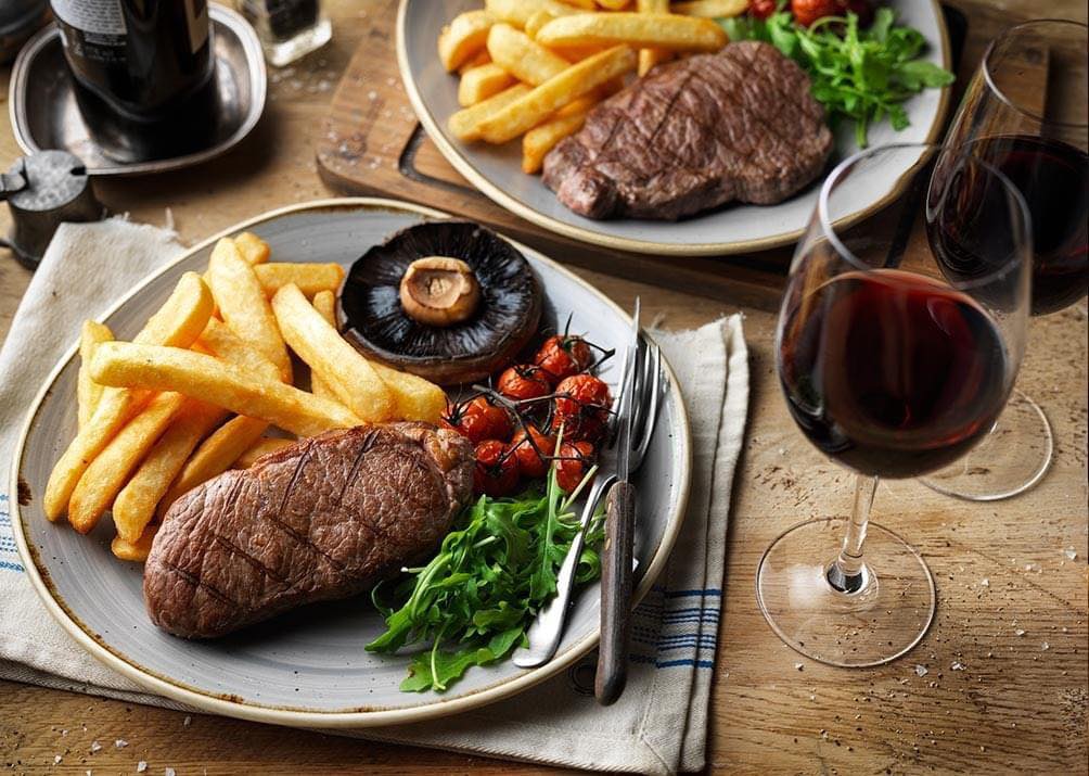 Steak, Chips and vegetables with a glass of wine