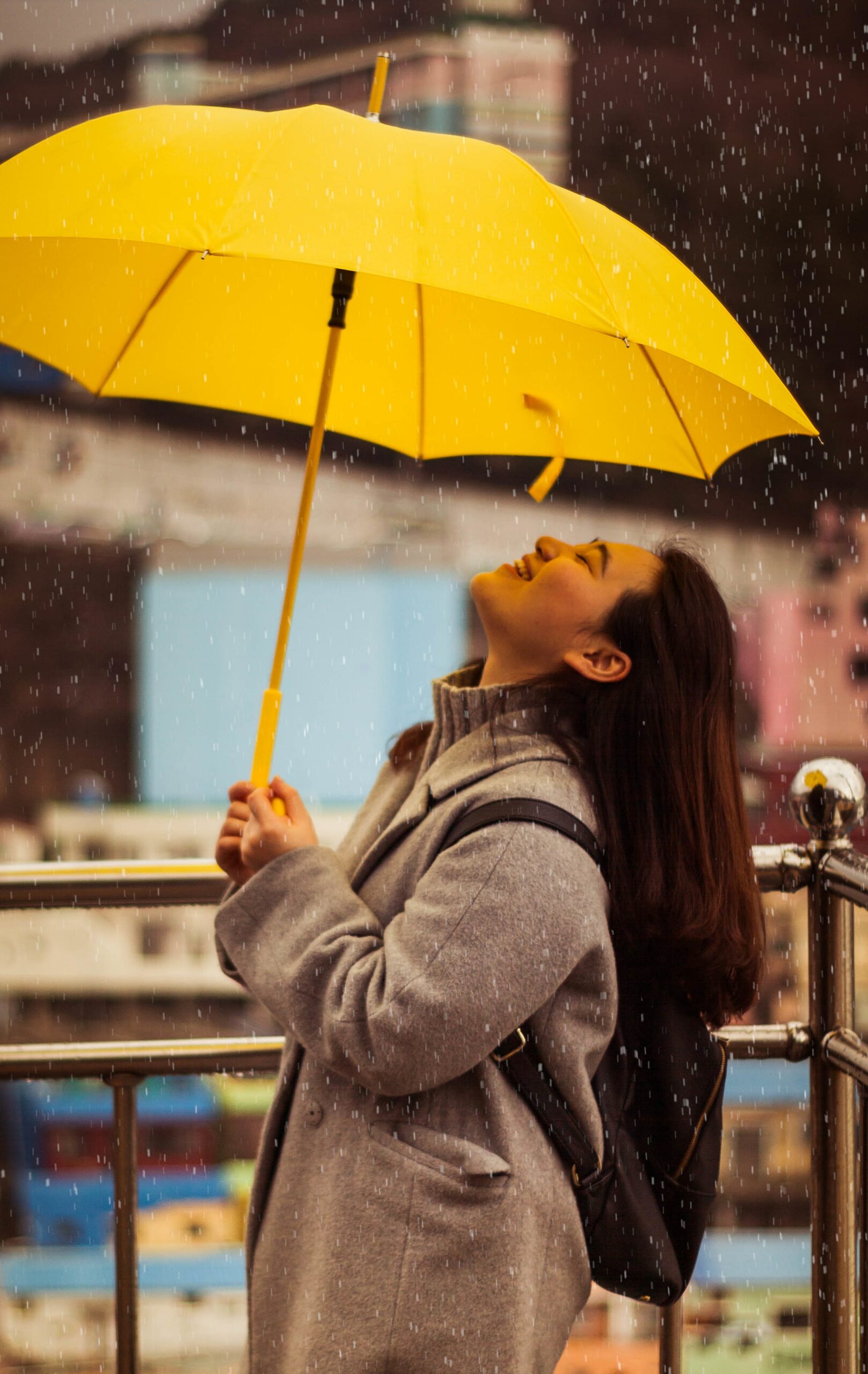 woman holding a yellow umbrella